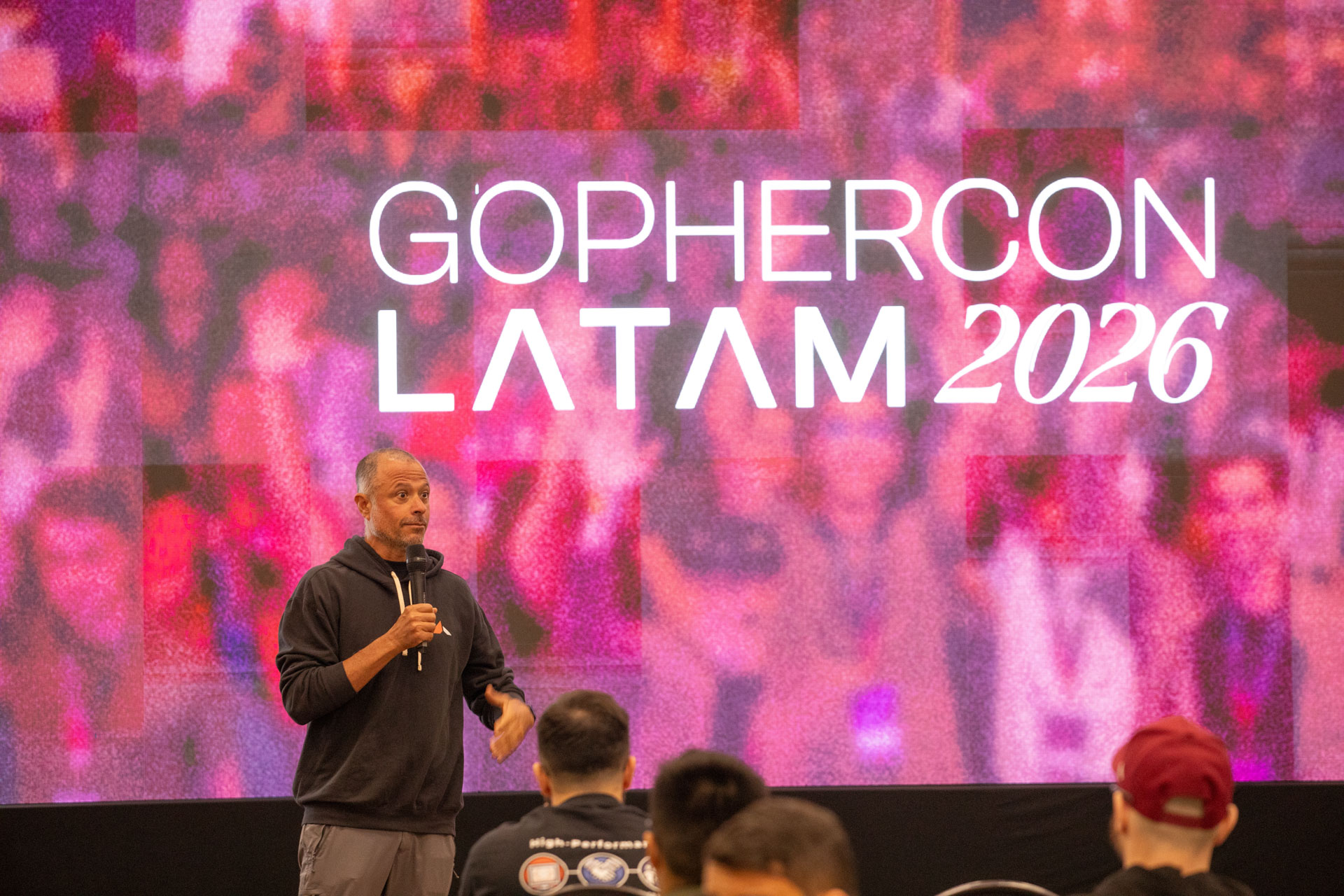 GopherCon LATAM 2026 — MJ addressing the room beneath the GopherCon LATAM 2026 branding.