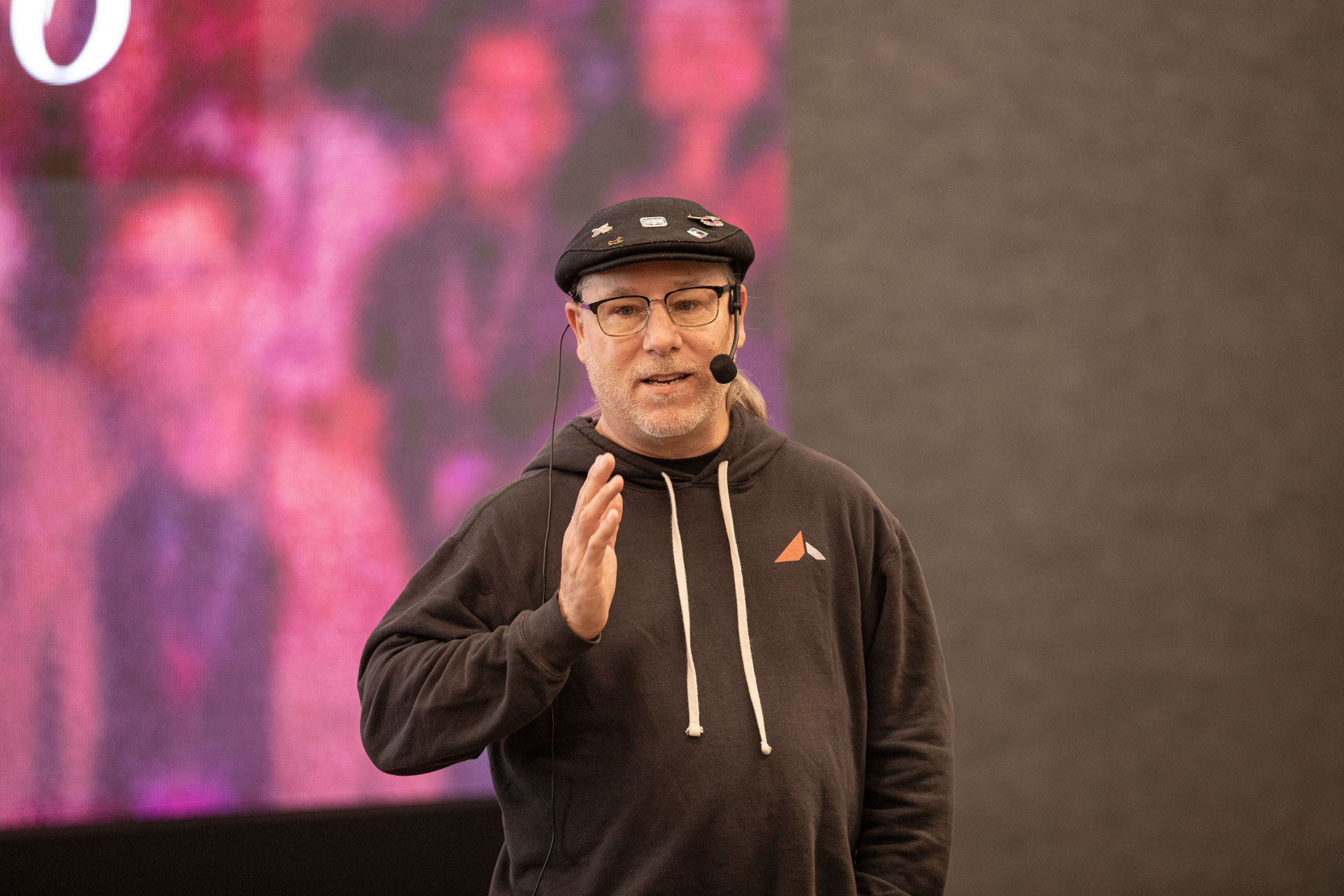 GopherCon LATAM 2026 — Bill Kennedy presenting in his flat cap and headset microphone.