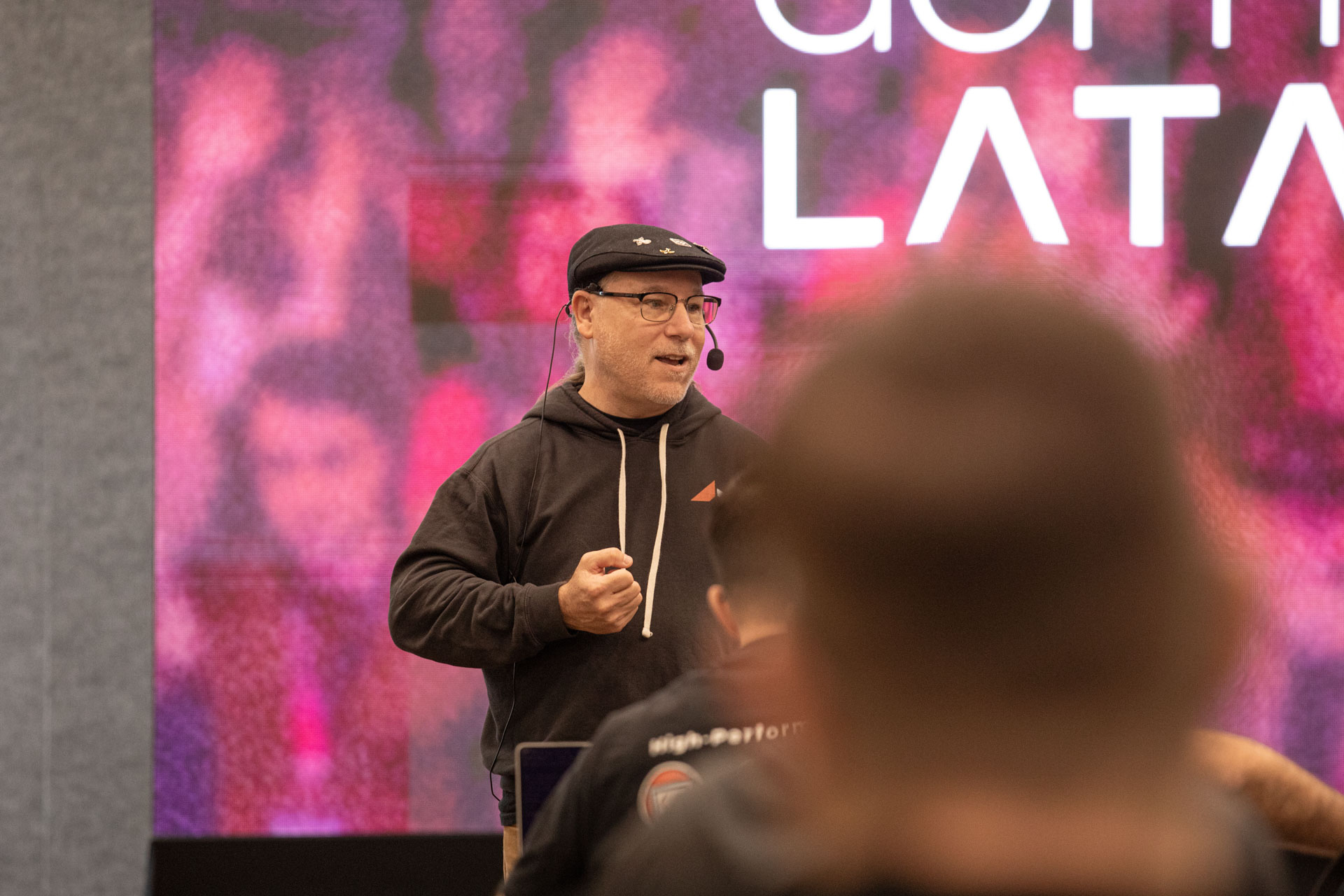 GopherCon LATAM 2026 — Bill Kennedy gesturing as he explains a concept on stage.