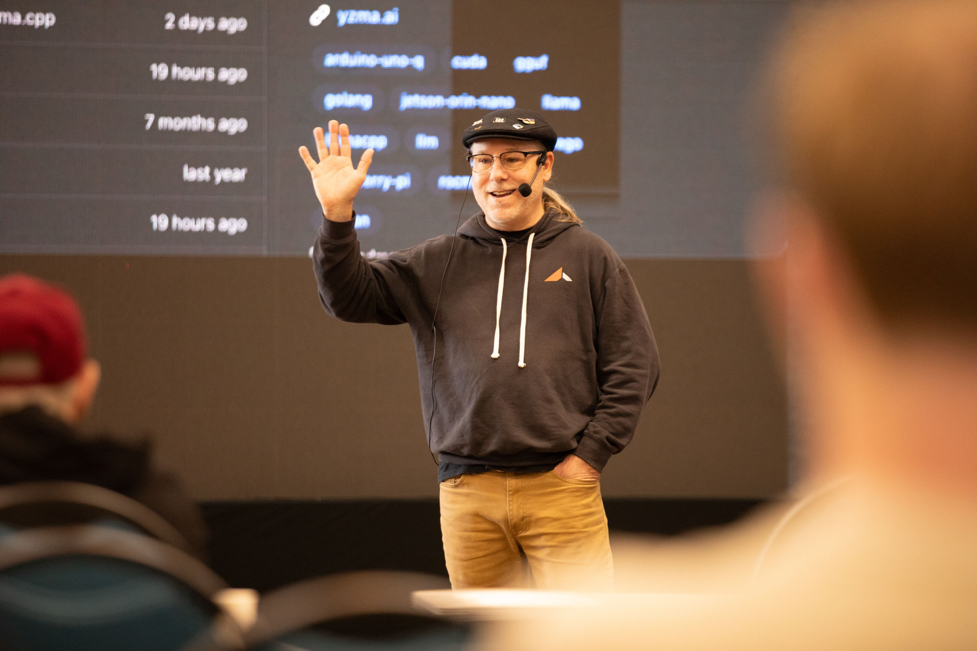 GopherCon LATAM 2026 — Bill Kennedy greeting attendees beside a terminal of Go and llama.cpp repos.