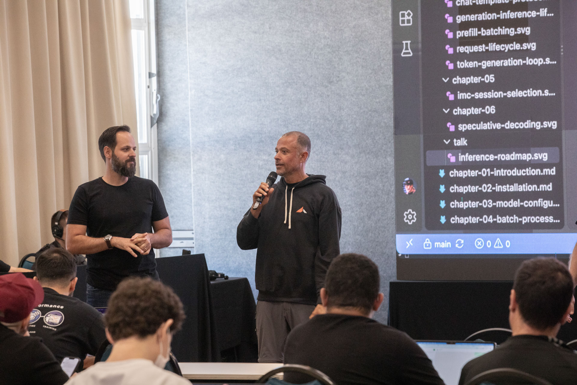 GopherCon LATAM 2026 — MJ and a co-presenter walking the room through the inference roadmap repo.