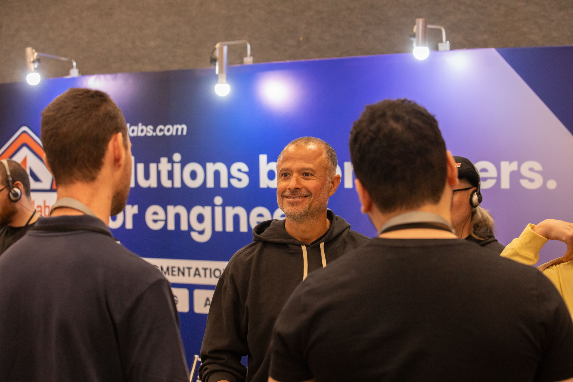 GopherCon LATAM 2026 — MJ talking with attendees at the Ardan Labs sponsor booth.