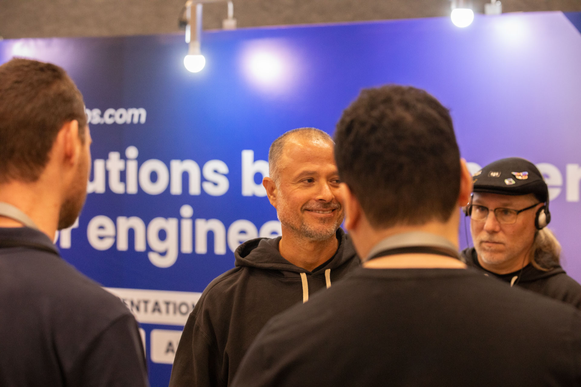 GopherCon LATAM 2026 — MJ and Bill Kennedy meeting attendees at the Ardan Labs booth.