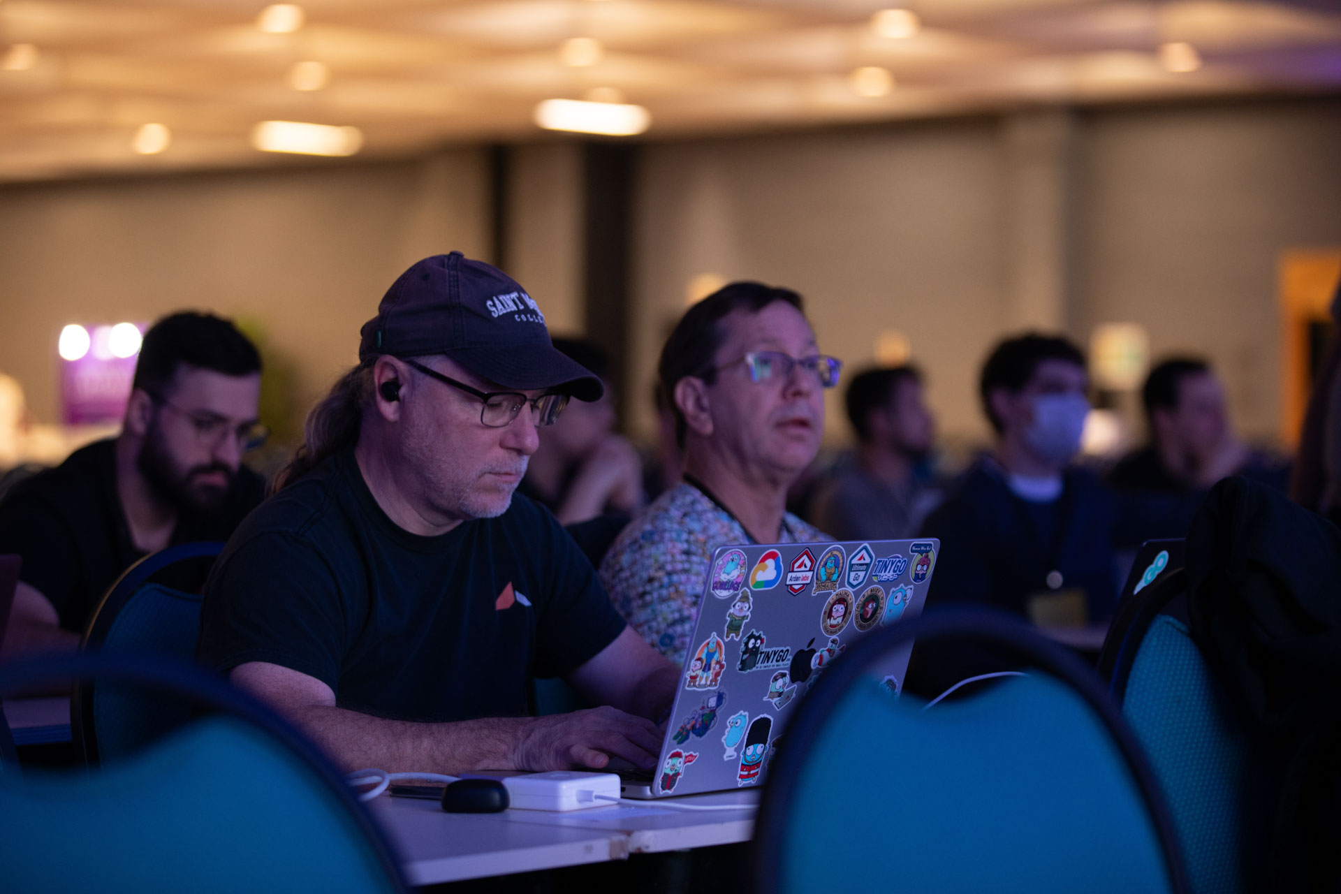 GopherCon LATAM 2026 — Bill Kennedy coding on his laptop in the main ballroom.