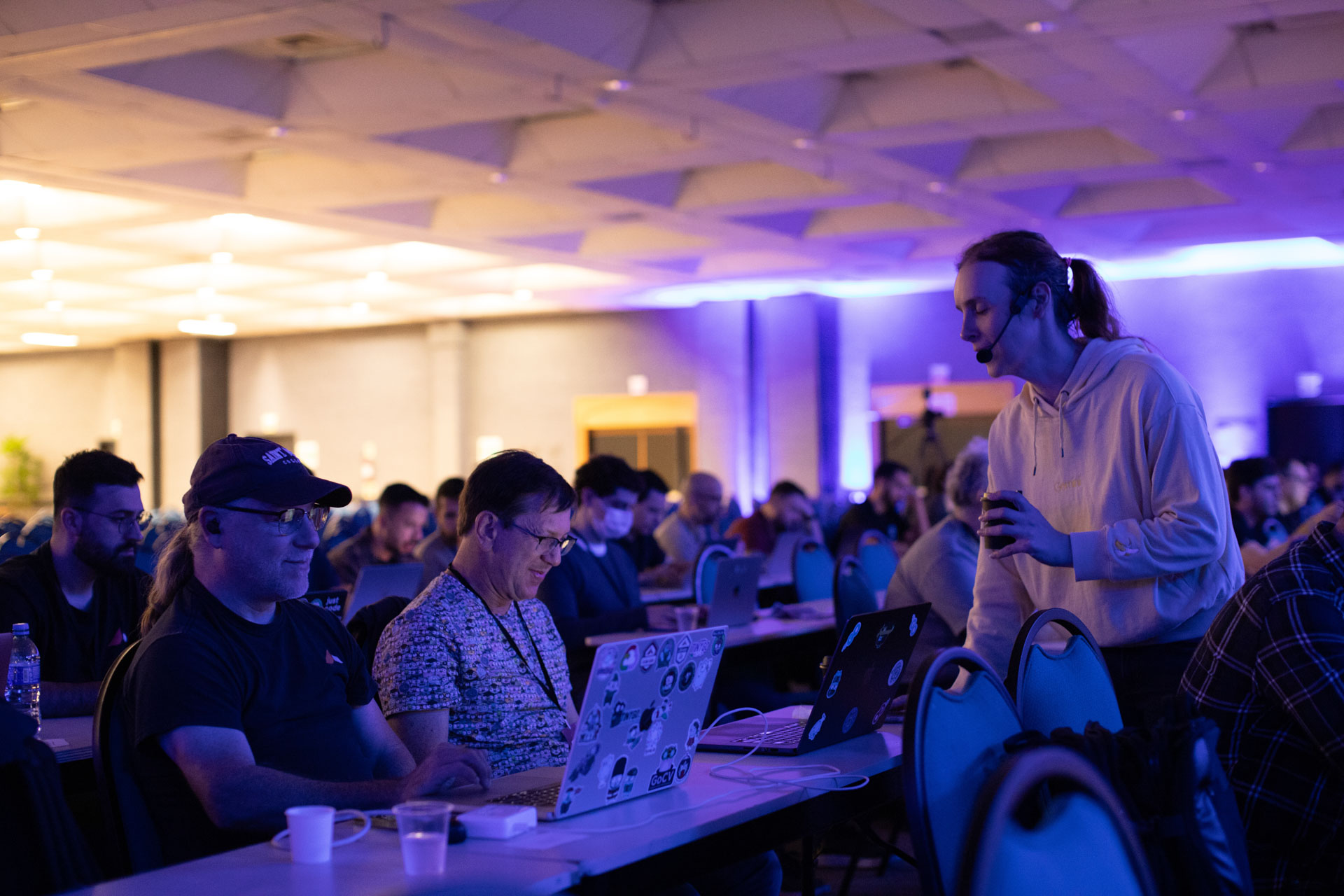 GopherCon LATAM 2026 — a volunteer checking in with Bill Kennedy during a session.