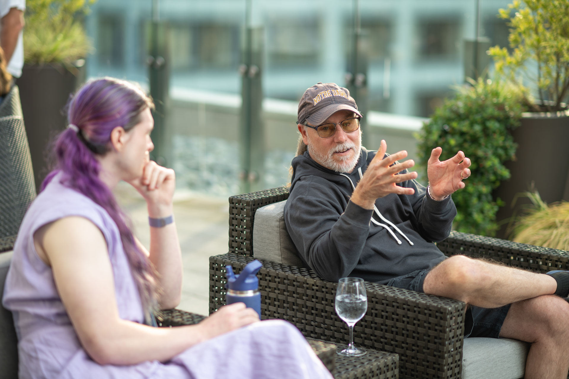 GopherCon US 2026 — Bill Kennedy talking Go with an attendee on the rooftop.