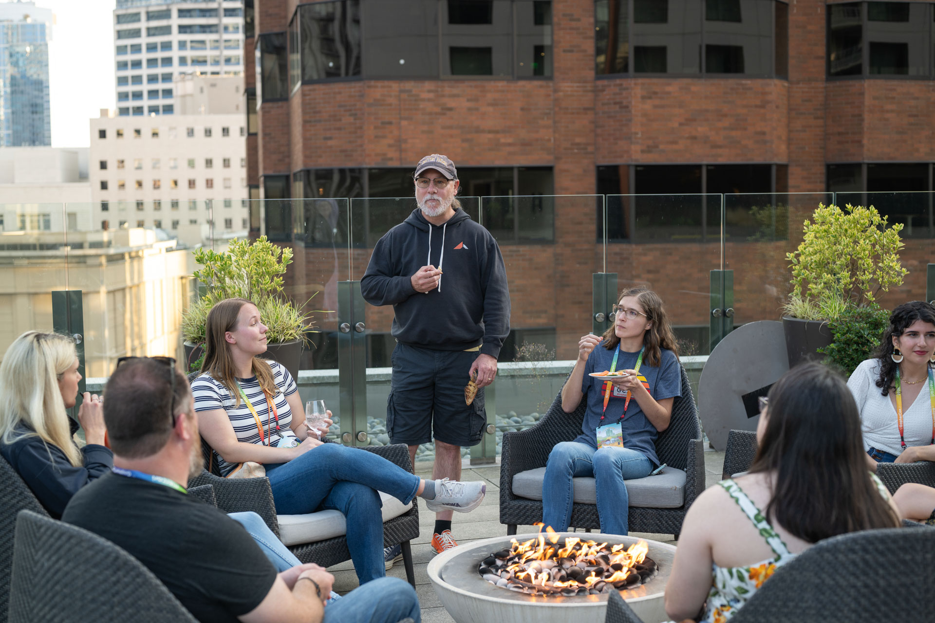 GopherCon US 2026 — Bill Kennedy speaking to attendees around the rooftop fire pit.