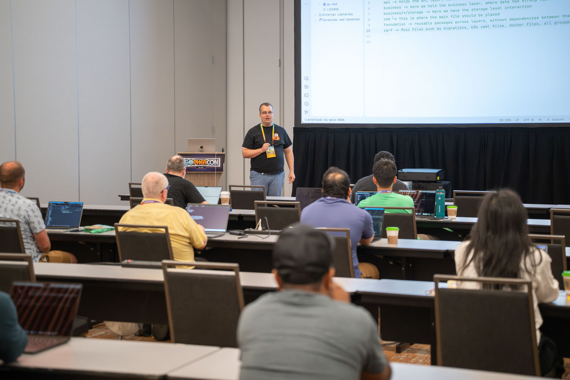 GopherCon US 2026 — Florin Pățan reviewing a Go project layout with the workshop room.