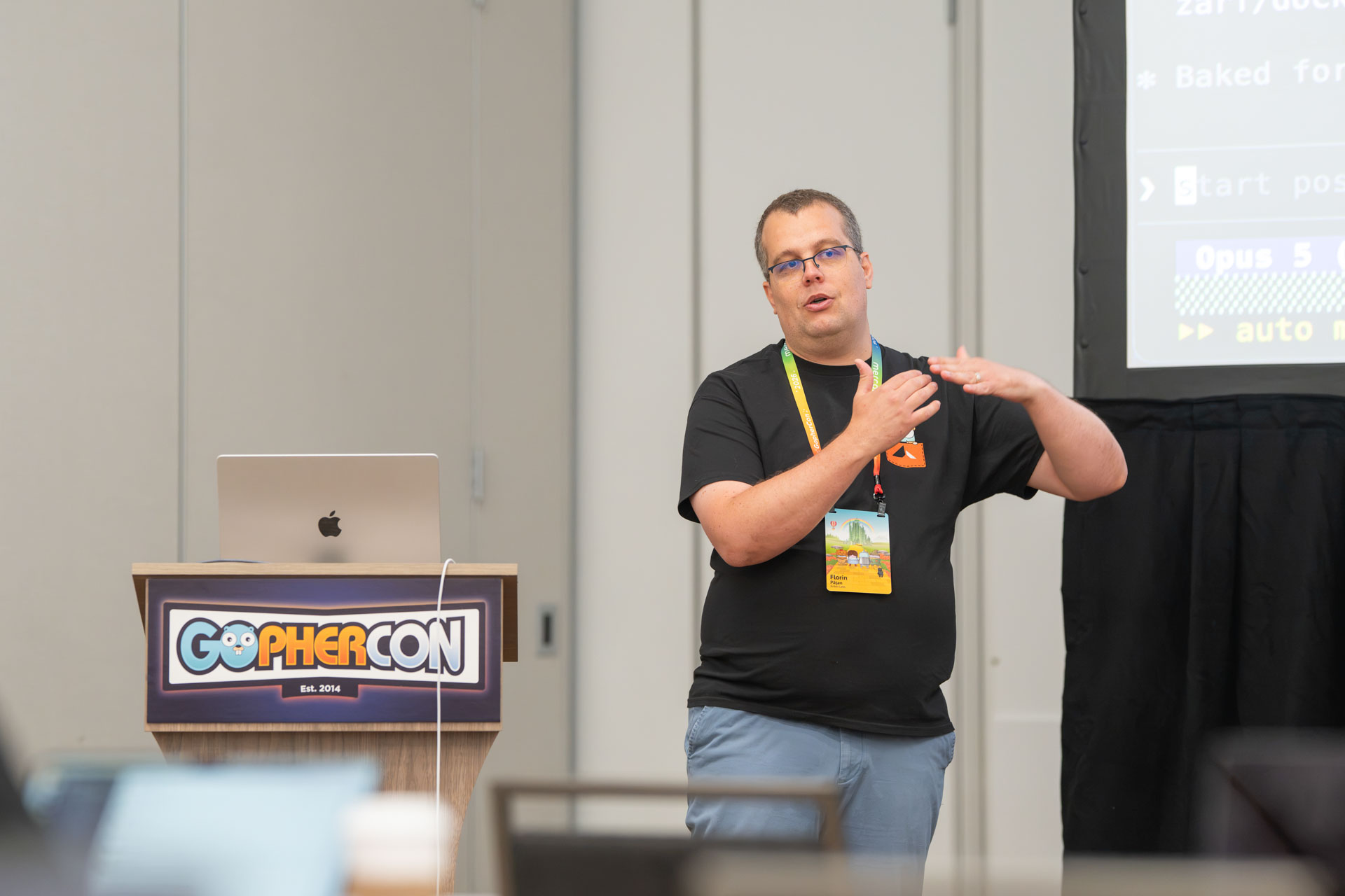 GopherCon US 2026 — Florin Pățan demonstrating a model configuration on the projector.