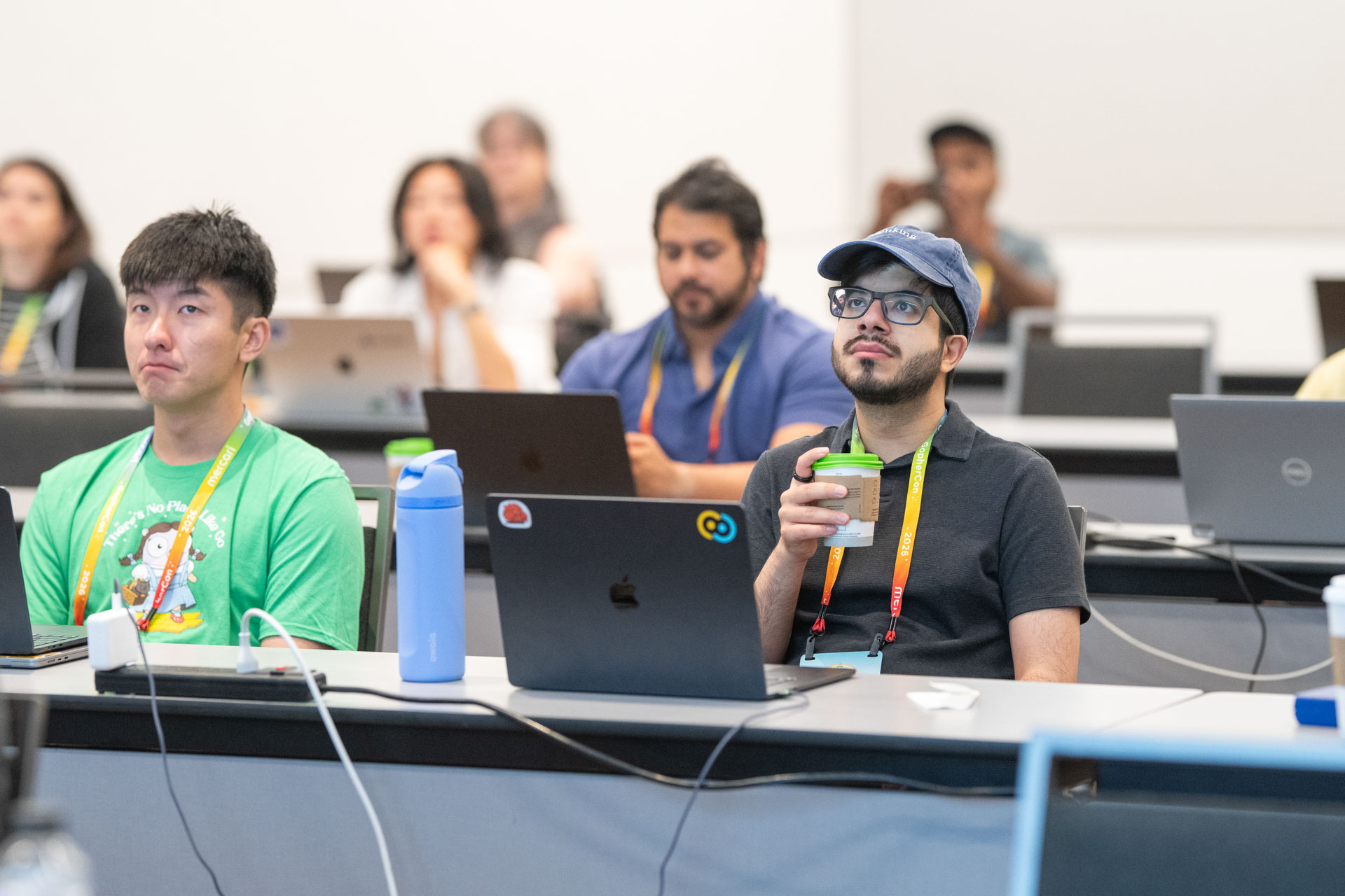 GopherCon US 2026 — attendees watching a demo, coffee in hand, at the AI workshop.
