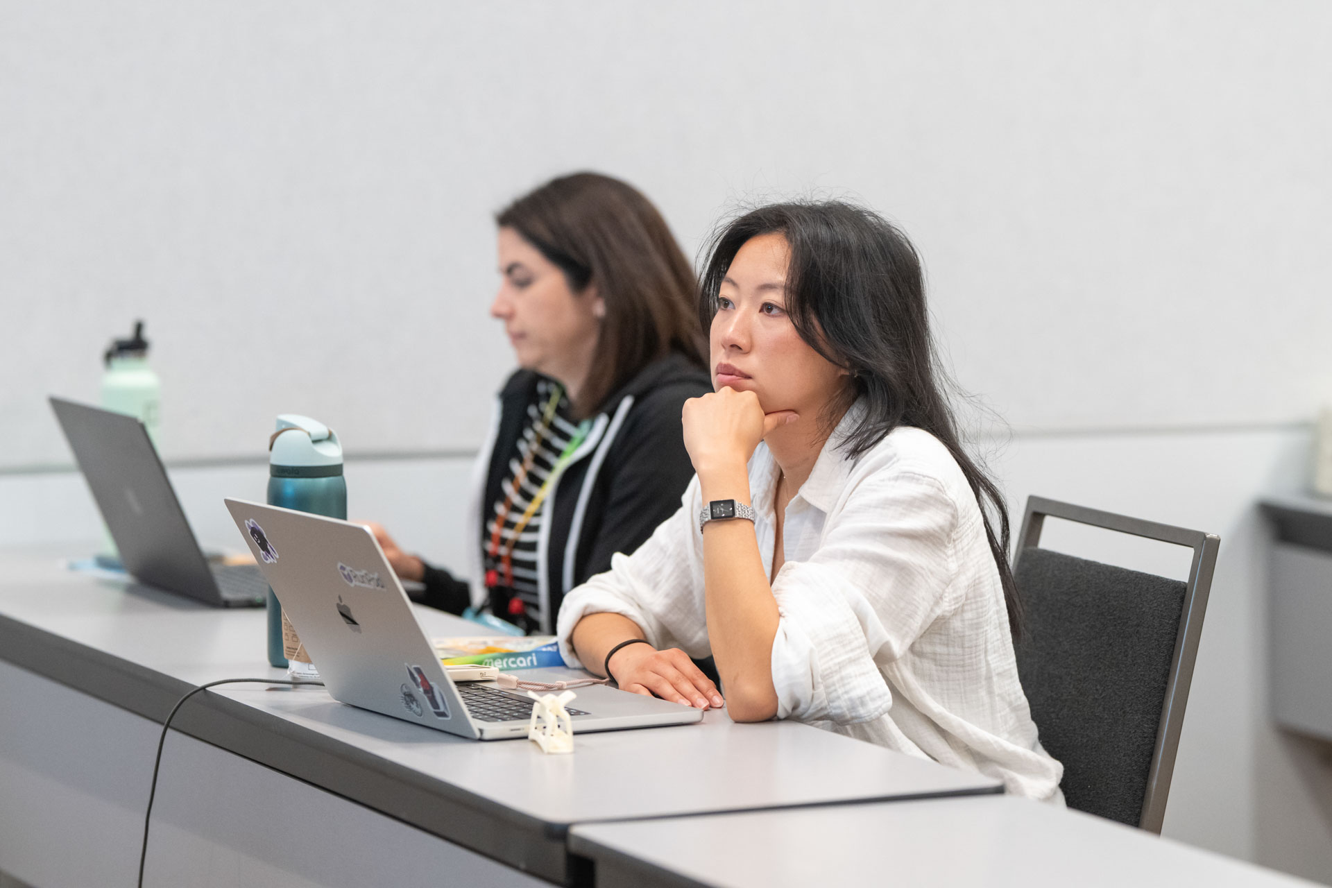 GopherCon US 2026 — two attendees listening during an AI workshop session.
