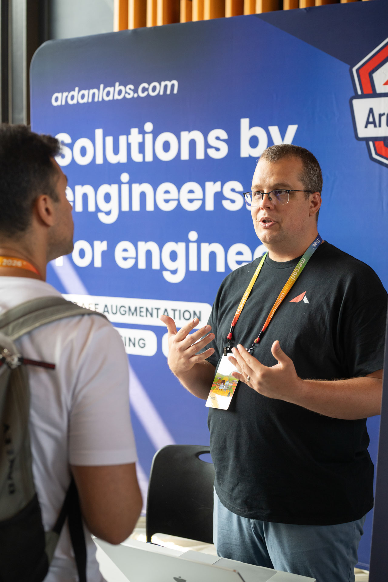 GopherCon US 2026 — Florin Pățan discussing Ardan Labs consulting and staff augmentation at the booth.
