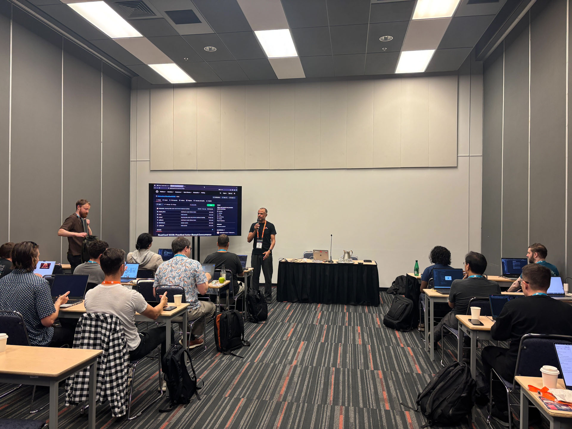 RustConf 2026 — MJ walking the workshop through the course repository on screen.