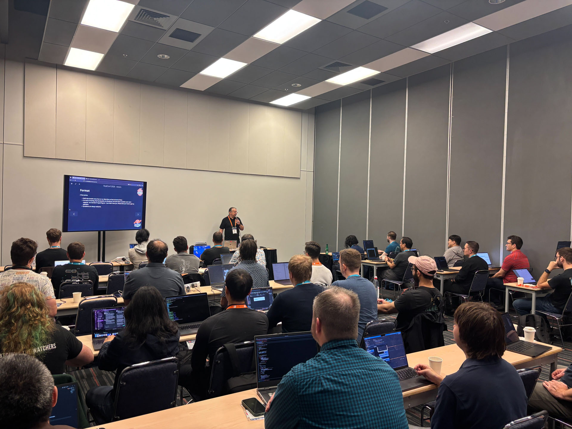 RustConf 2026 — MJ introducing the workshop foreword to a packed classroom.