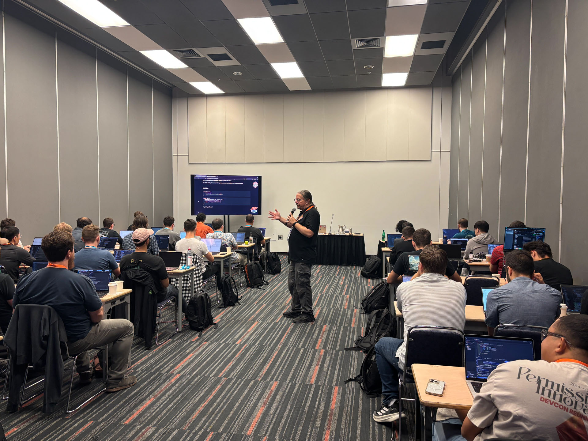 RustConf 2026 — Herbert Wolverson teaching from the middle of the workshop room.