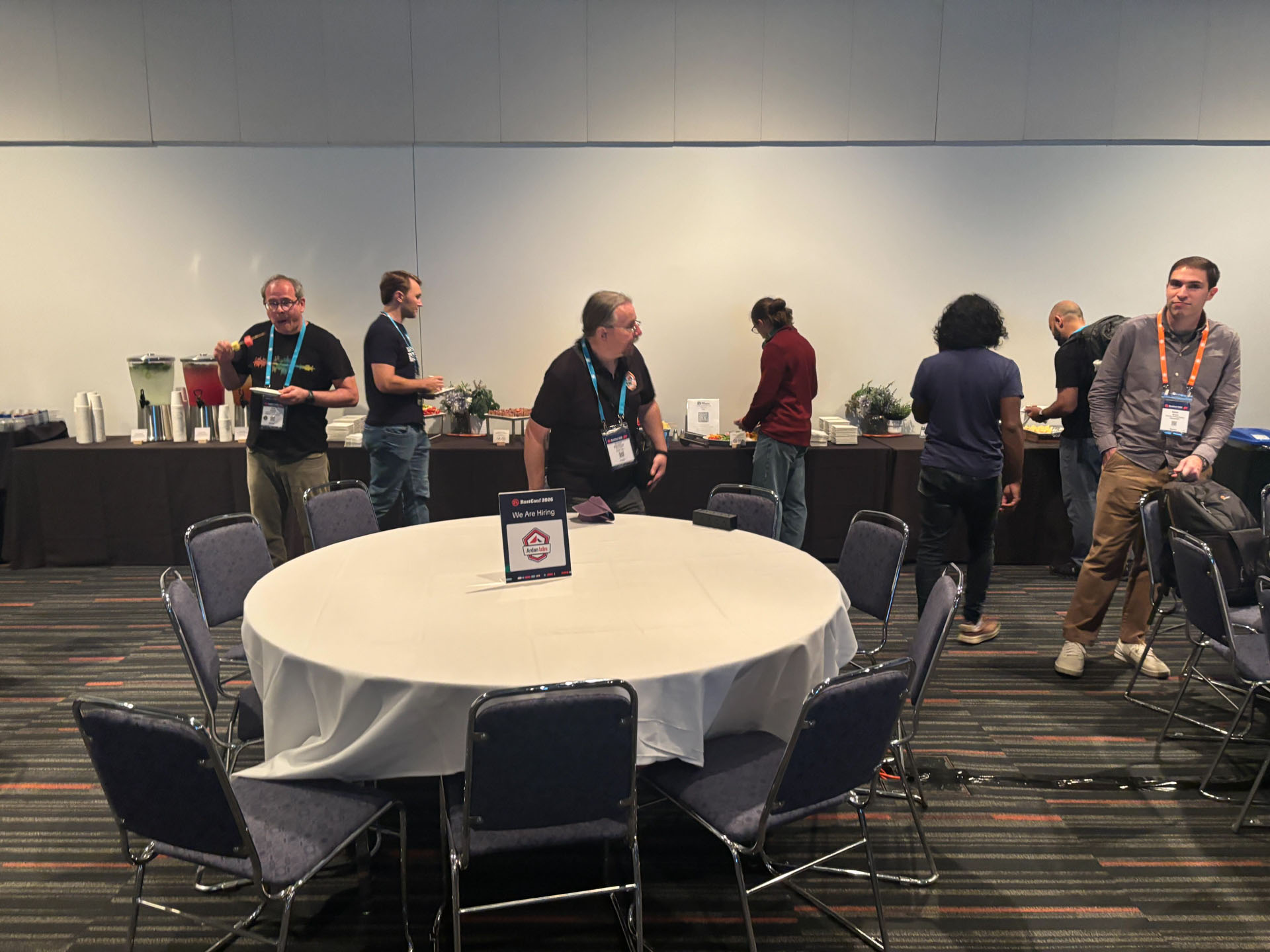 RustConf 2026 — attendees gathering around the refreshment table at the Career Crawl.