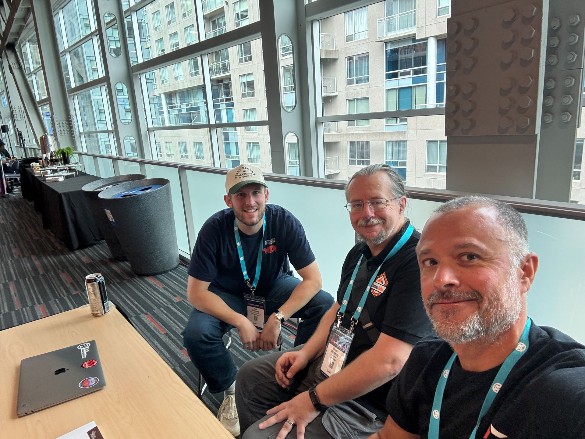 RustConf 2026 — MJ and Herbert Wolverson taking a break with an attendee overlooking Montréal.