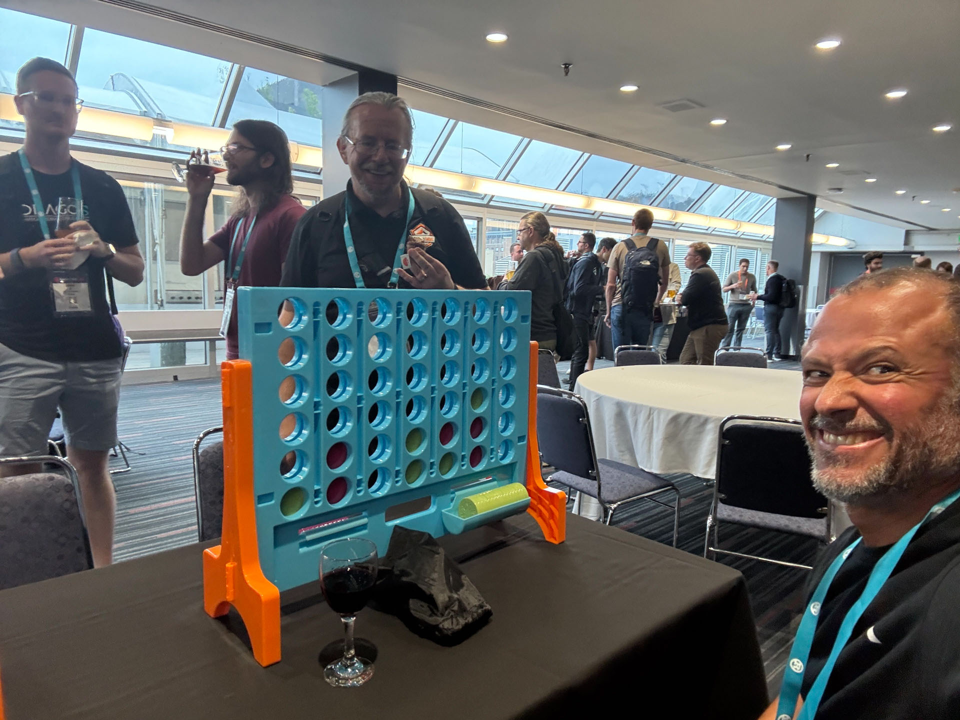 RustConf 2026 — Herbert Wolverson and MJ at the giant Connect Four game during the reception.