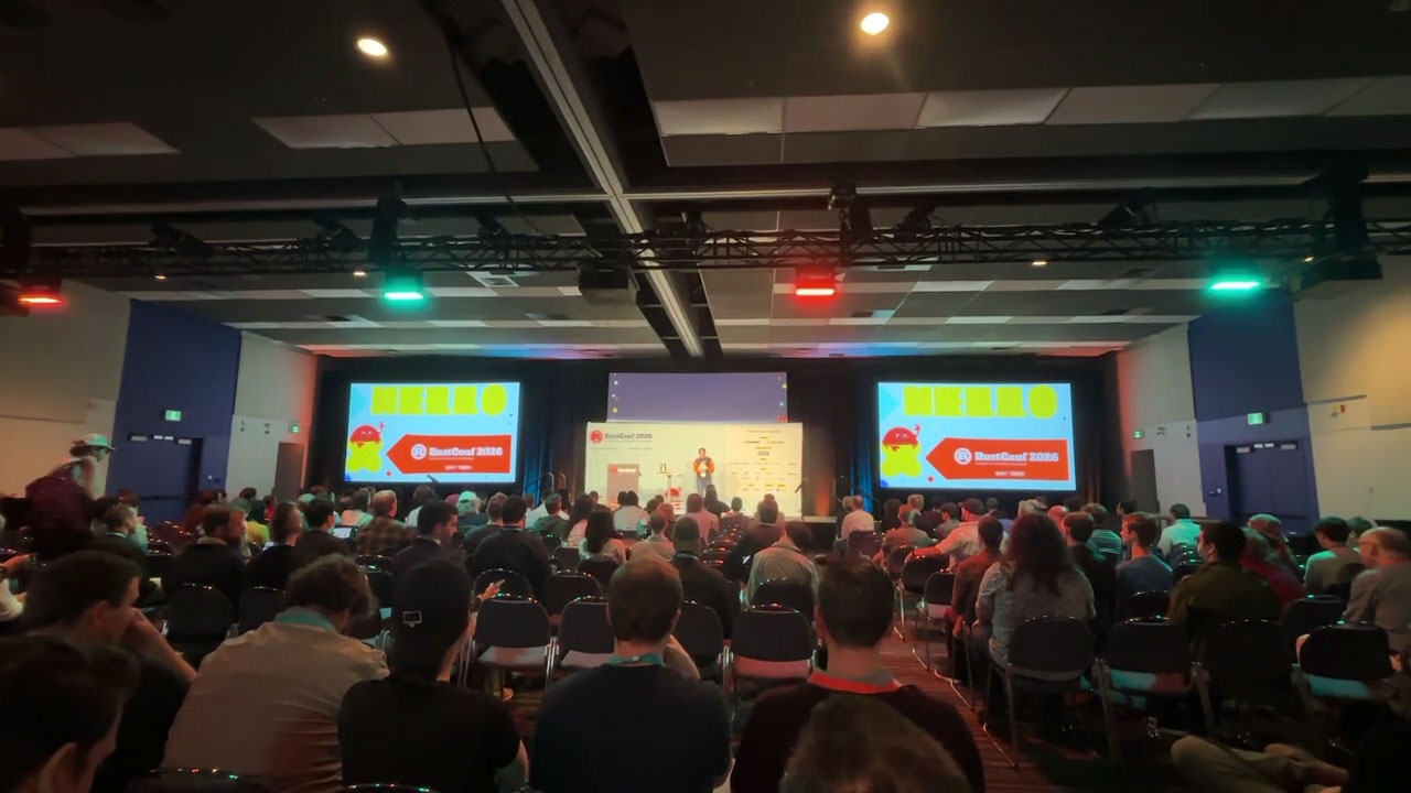 RustConf 2026 — a full auditorium during a RustConf main stage session.