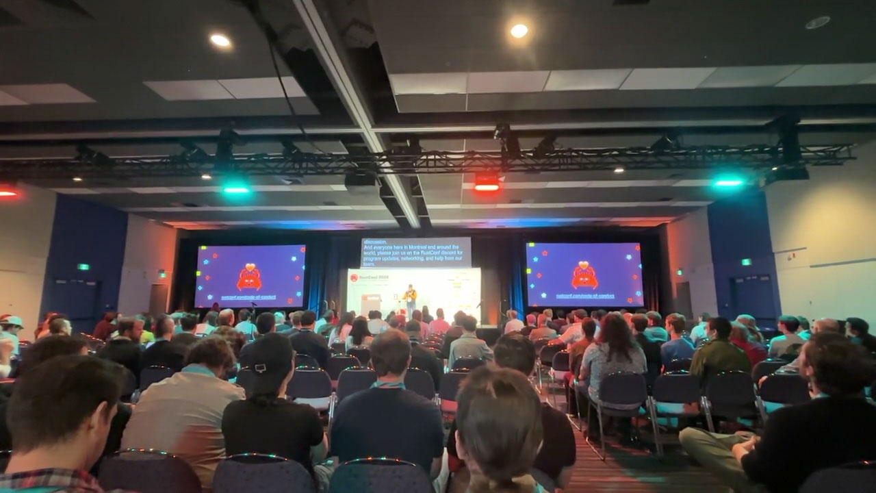 RustConf 2026 — attendees seated for a talk in the main auditorium.