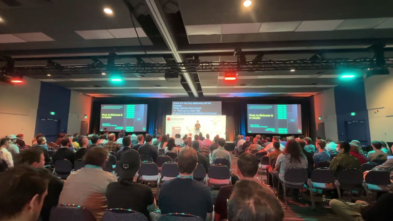 RustConf 2026 — a wide view of the main auditorium mid-keynote.