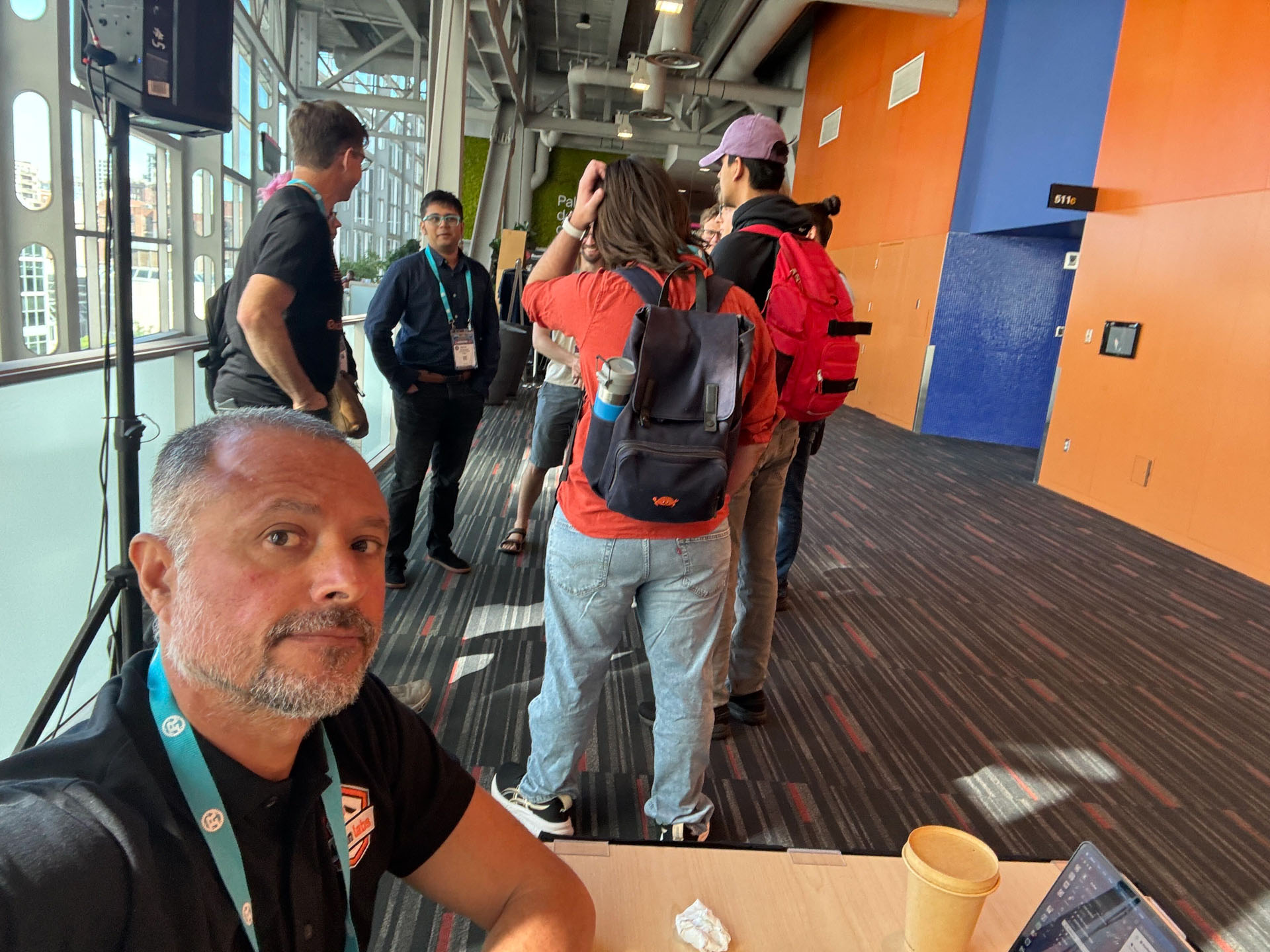 RustConf 2026 — MJ at the Ardan Labs table as attendees head to the next session.