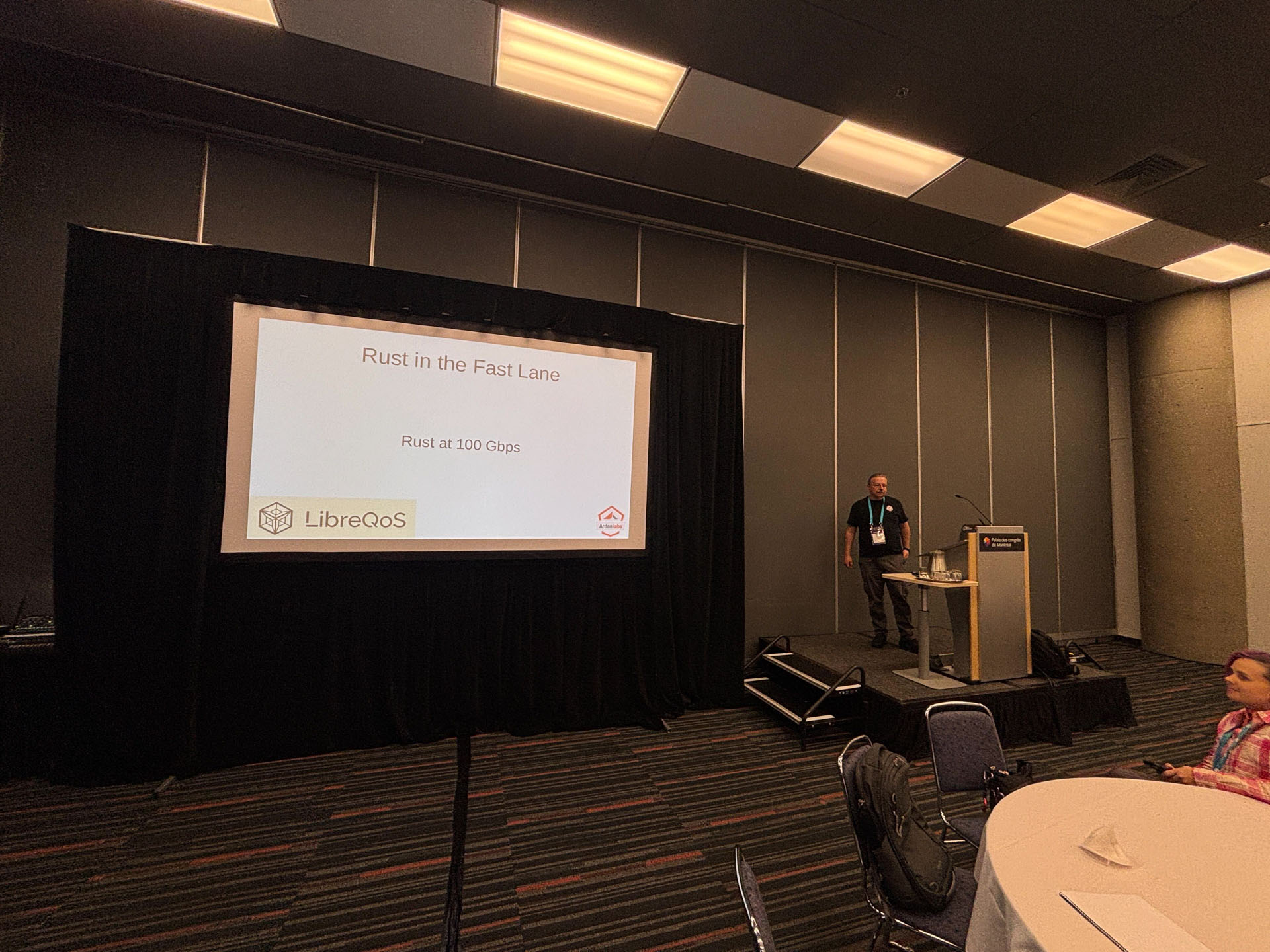 RustConf 2026 — Herbert Wolverson at the podium for Rust in the Fast Lane.