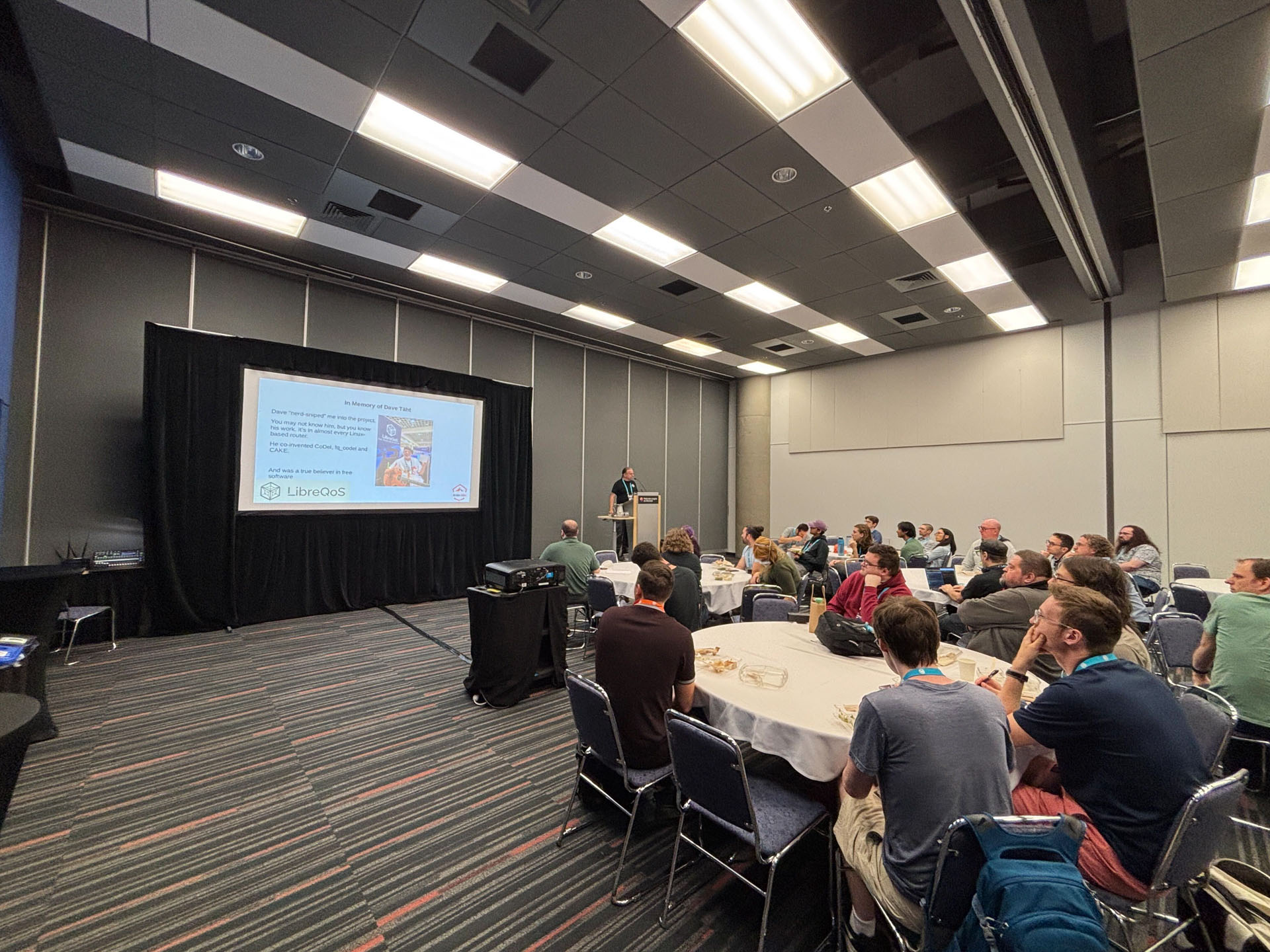 RustConf 2026 — attendees listening to Rust in the Fast Lane from round tables.