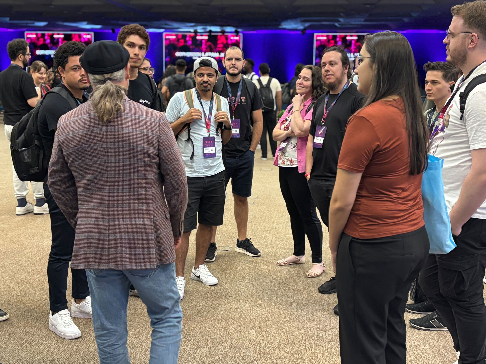 Crowded conference or meetup space with engineers exploring the venue